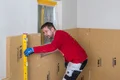 Die Position der Holzfaser-Dämmplatte Thermoroom wird mit einer Wasserwaage kontrolliert.