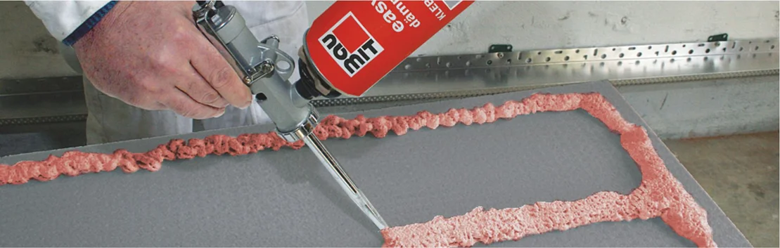 L'artisan applique de la mousse PU &agrave; l'aide d'un pistolet, id&eacute;al pour un travail de pr&eacute;cision dans le cadre de projets d'isolation et de construction.