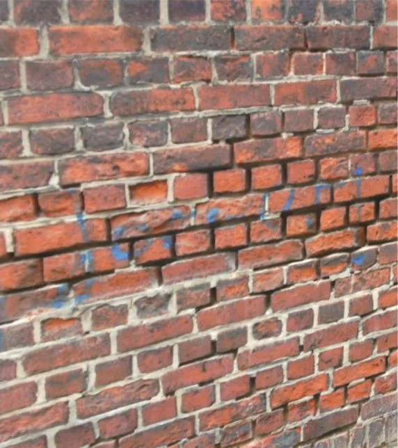 Gros plan sur un mur de briques aux joints irréguliers pour des projets de bricolage liés à la rénovation de façades et à l’aménagement mural.